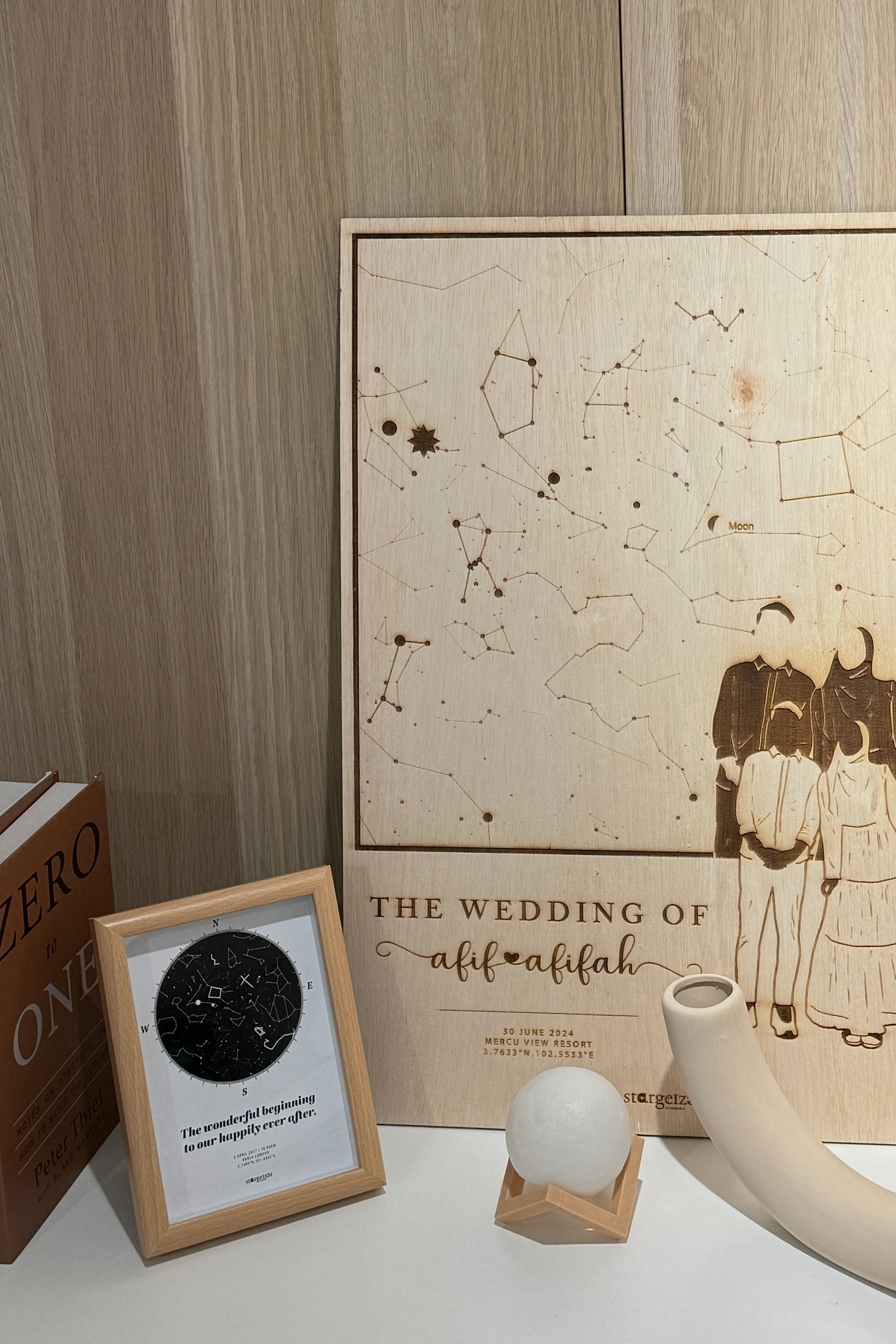 Custom wooden engraved wedding star map displayed with smaller framed constellations and decor, a unique Stargeizer wedding gift.